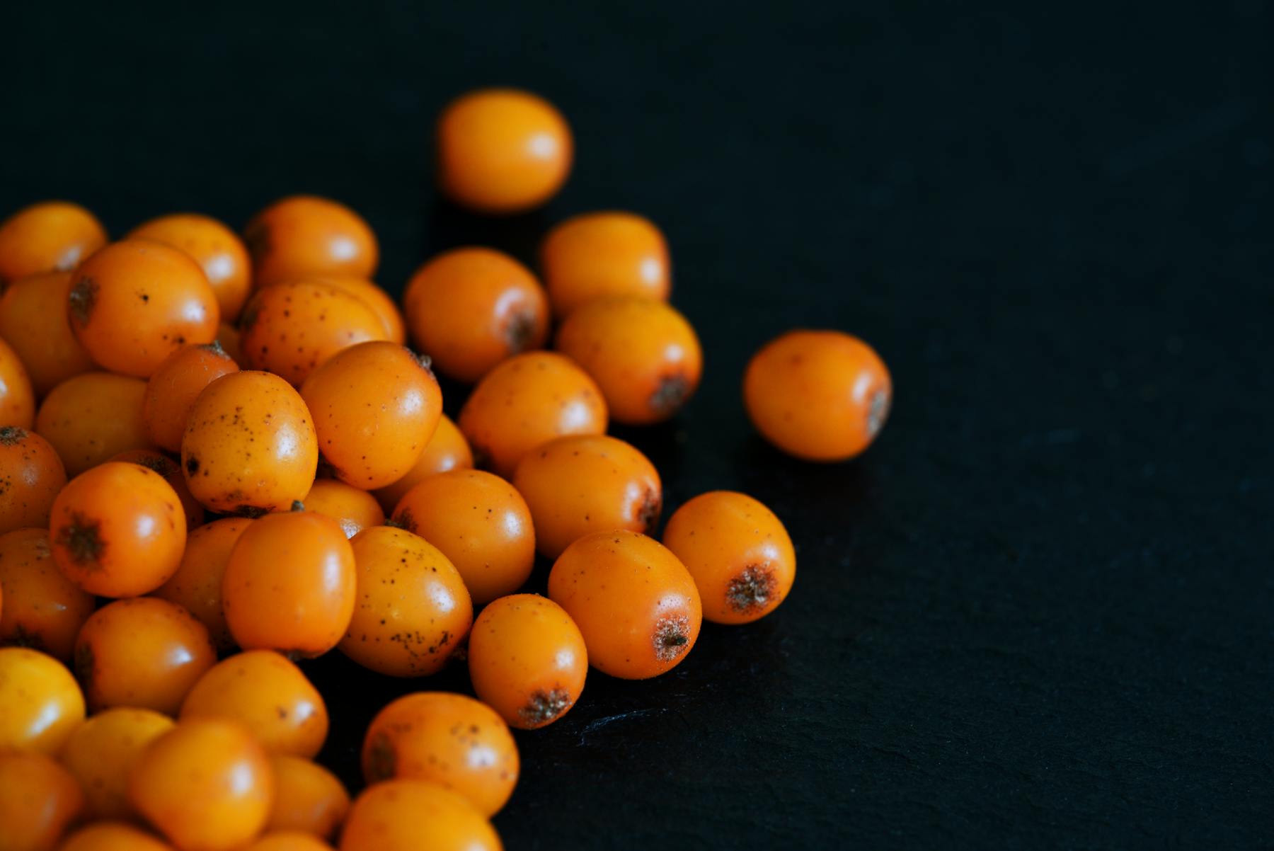 a bunch of oranges sitting on a wooden surface